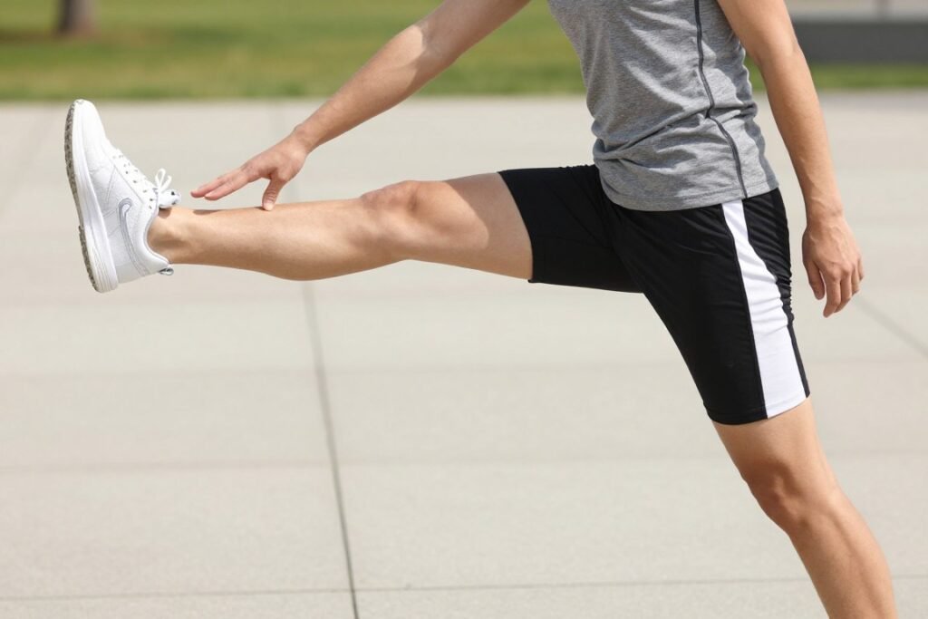 athletic person stretching muscles after exercise